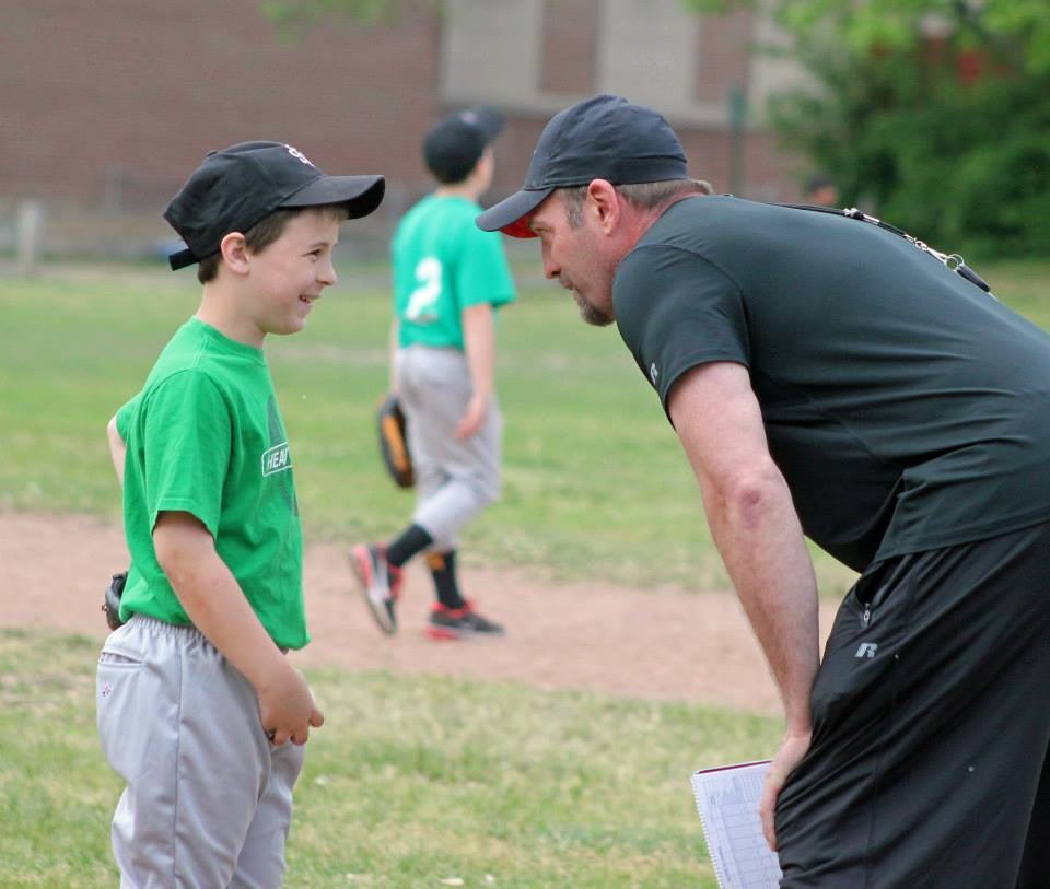 Baseball player with coach